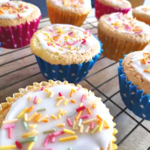 fairy cakes topped with icing and sprinkles