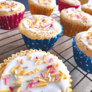 fairy cakes topped with icing and sprinkles