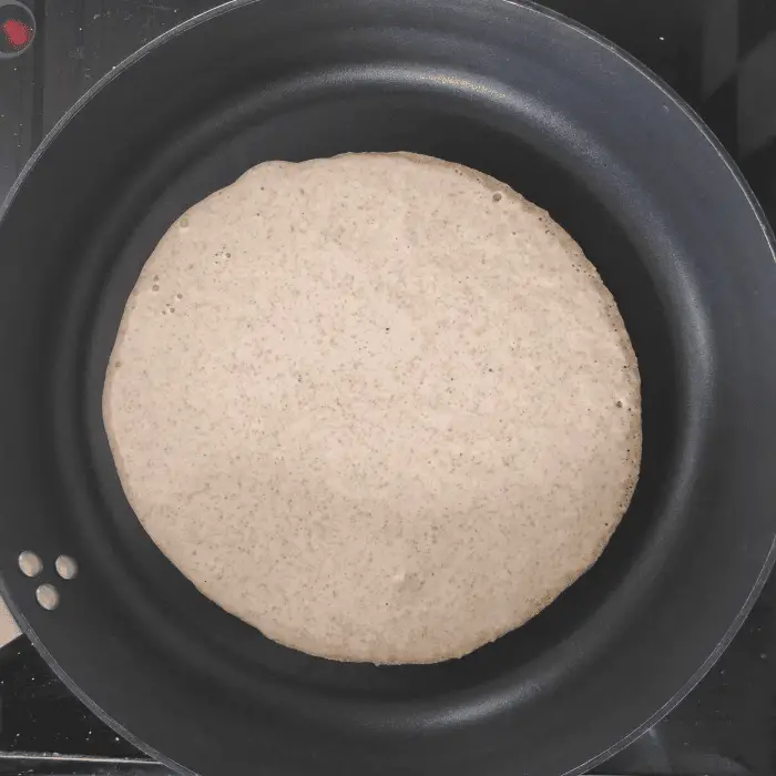 adding pancake to frying pan