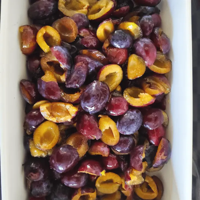 Plums cut in half and stone before baking