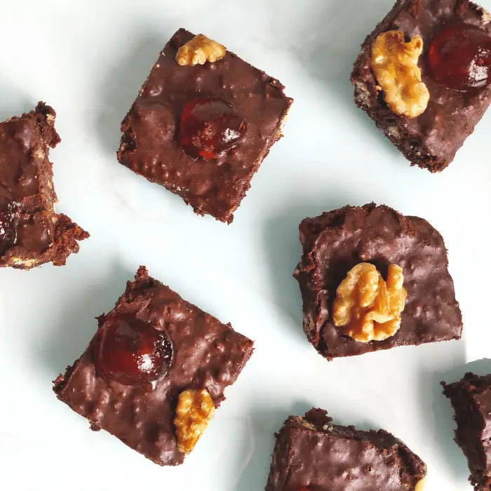 dark chocoalate squares with walnuts and cherries on top