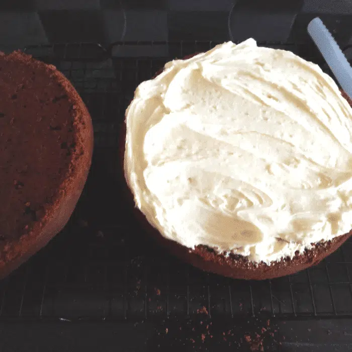 spreading buttercream on chocolate madeira cake uk
