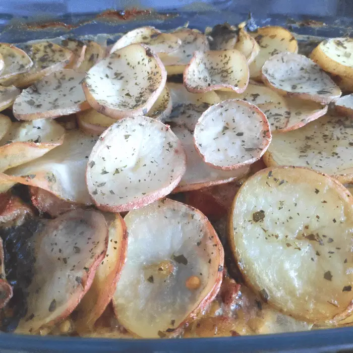 sausage bke topped with thin slices of potatoes