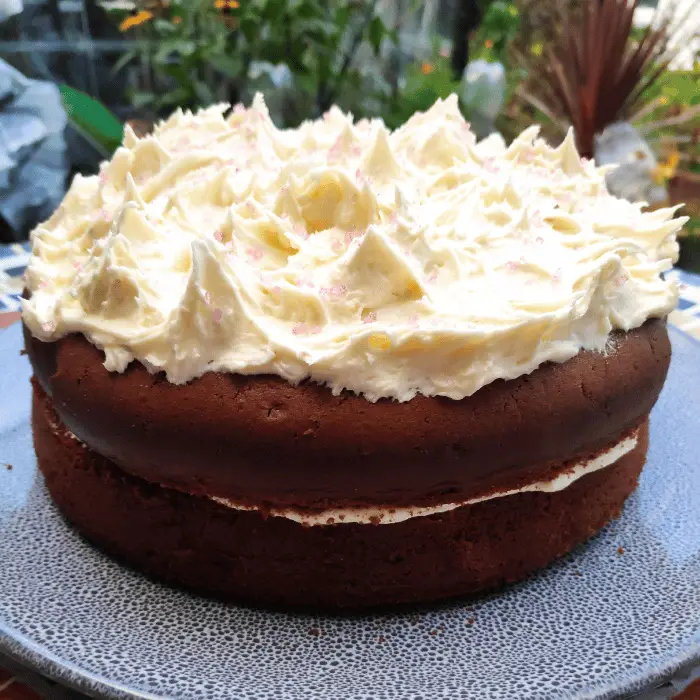 white chocolate buttercream on top of chocolate medeira cake