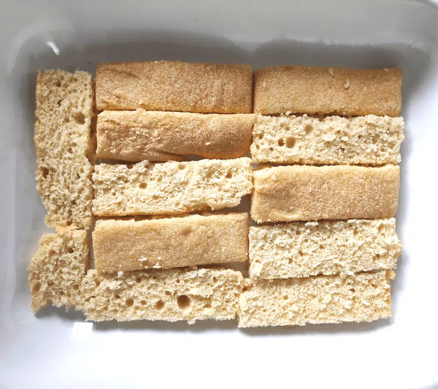 trifle sponges layered at the bottom of dish