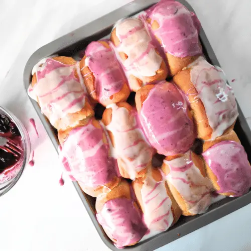 12 iced buns on a tray