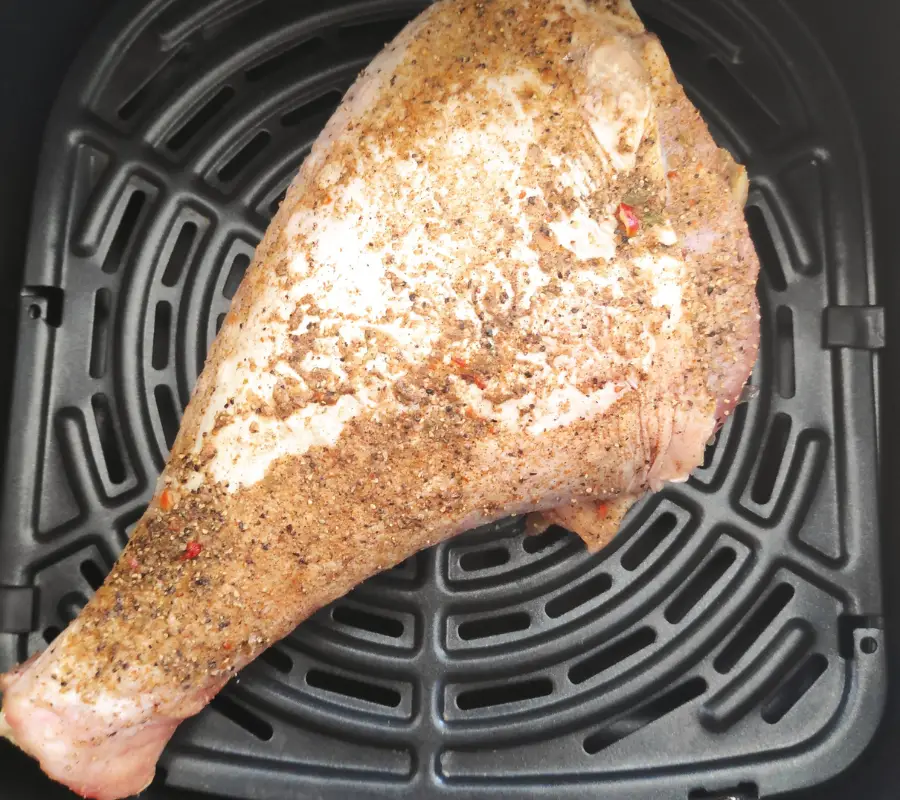 large turkey drumstick coated in spices in the air fryer