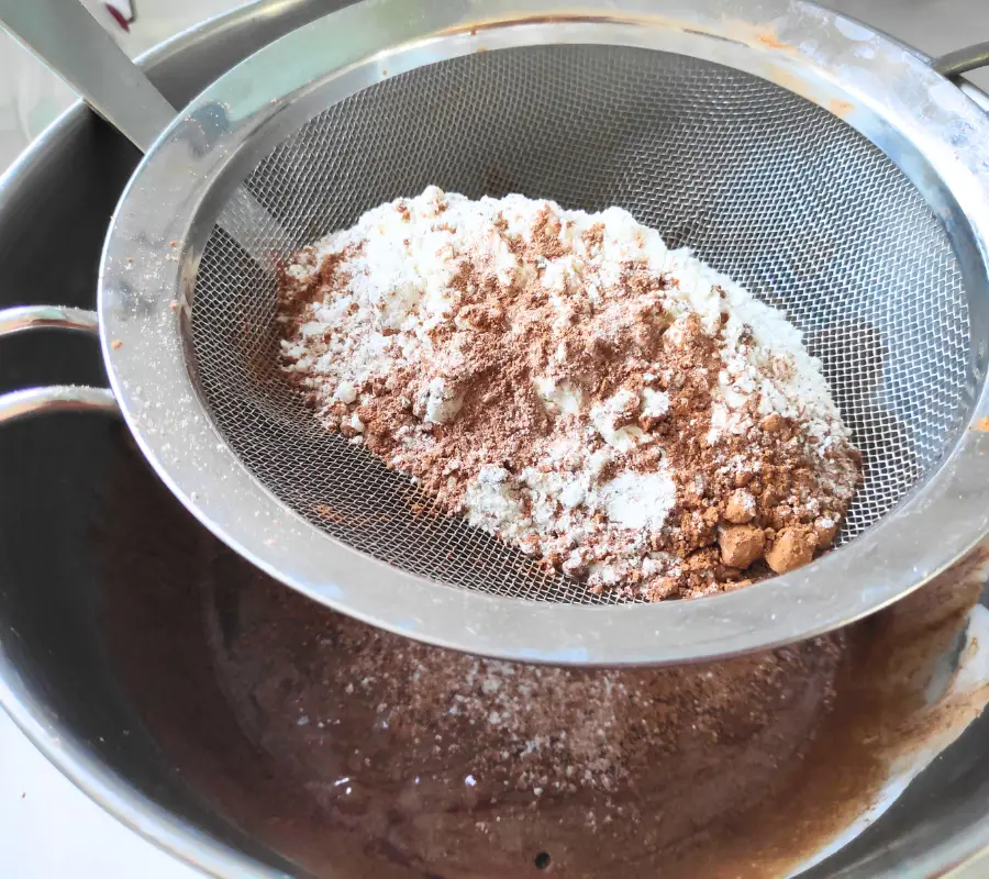 Sieve the flour and cocoa powder into the mixture