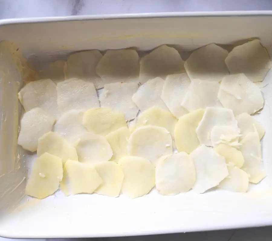 layering the potato slices for gratin dauphinois
