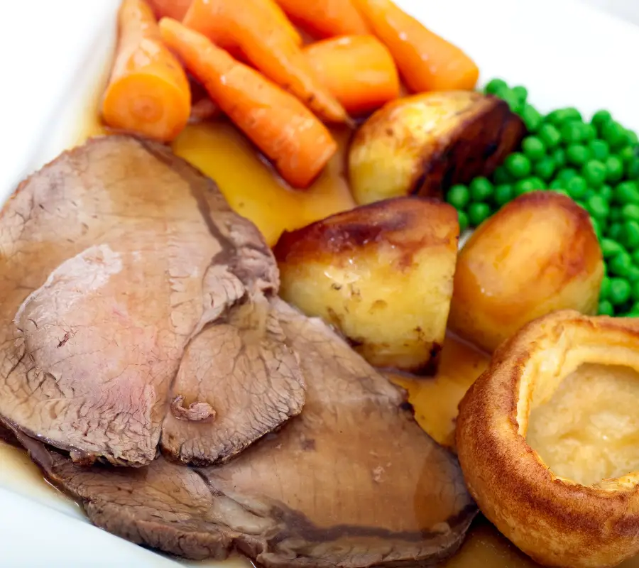 roast beef and Yorkshire pudding with gravy, carrots and peas