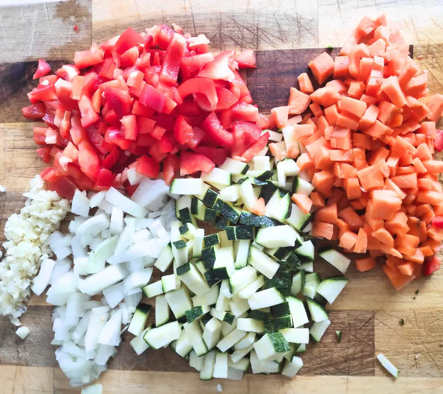 chopped vegetables on a wooden chopping board