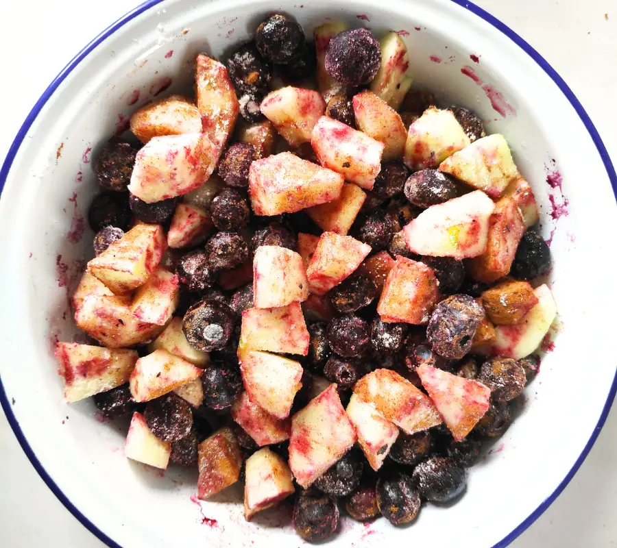 chopped apple and frozen blueberry in a dish
