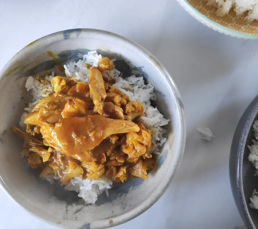 chicken curry in a bowl with rice