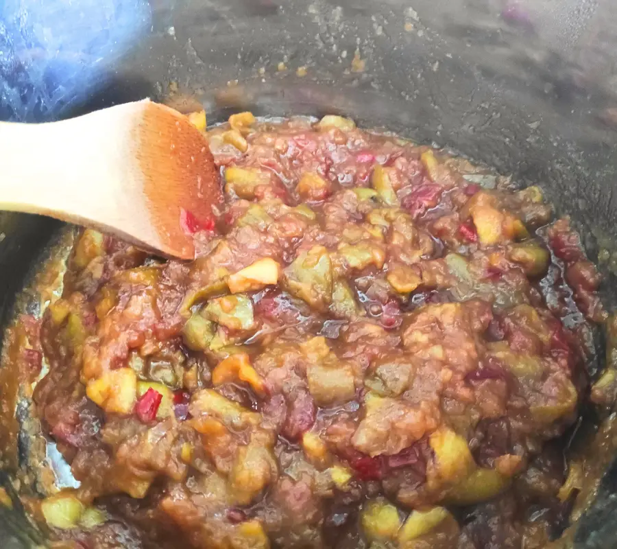 crab apple chilli chutney cooking in a stainless steel pan