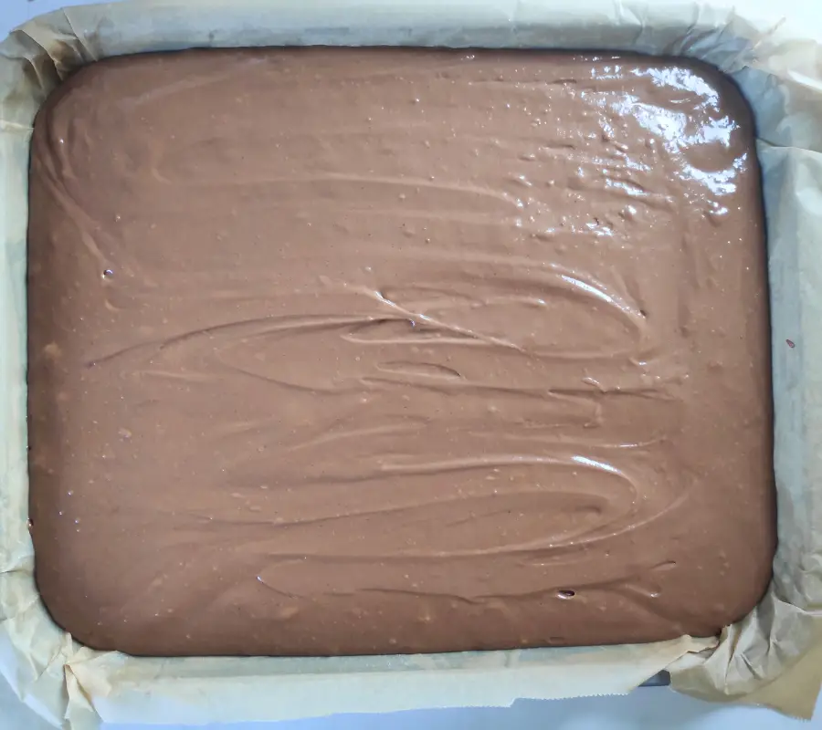 chocolate sponge mixture in a tin