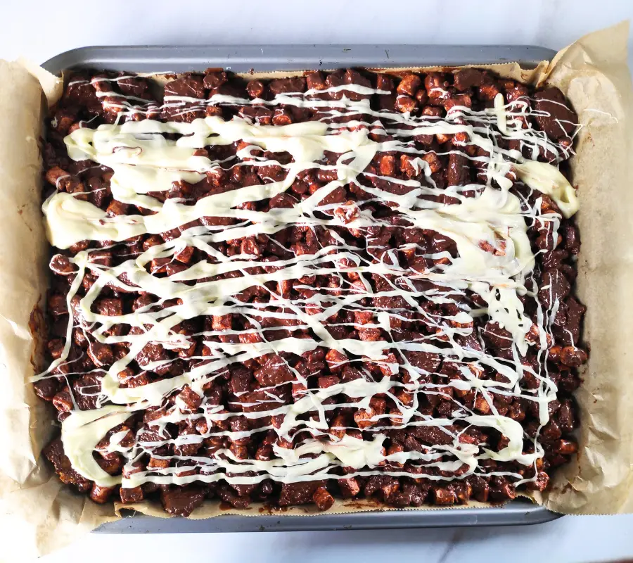 triple chocolate biscoff rocky road in a baking tray