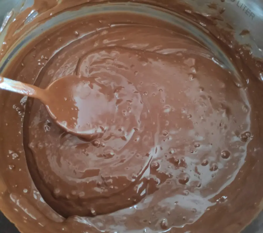 melted chocolate and biscoff spread in a pot