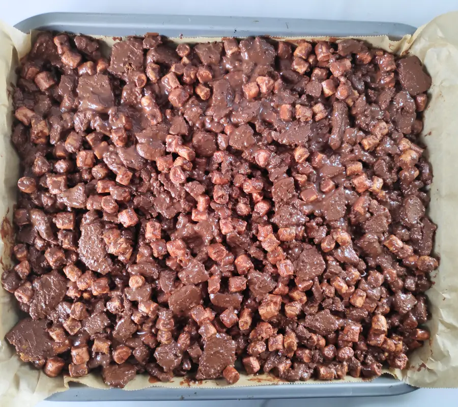 biscoff rocky road mixture spread out on a baking tray.