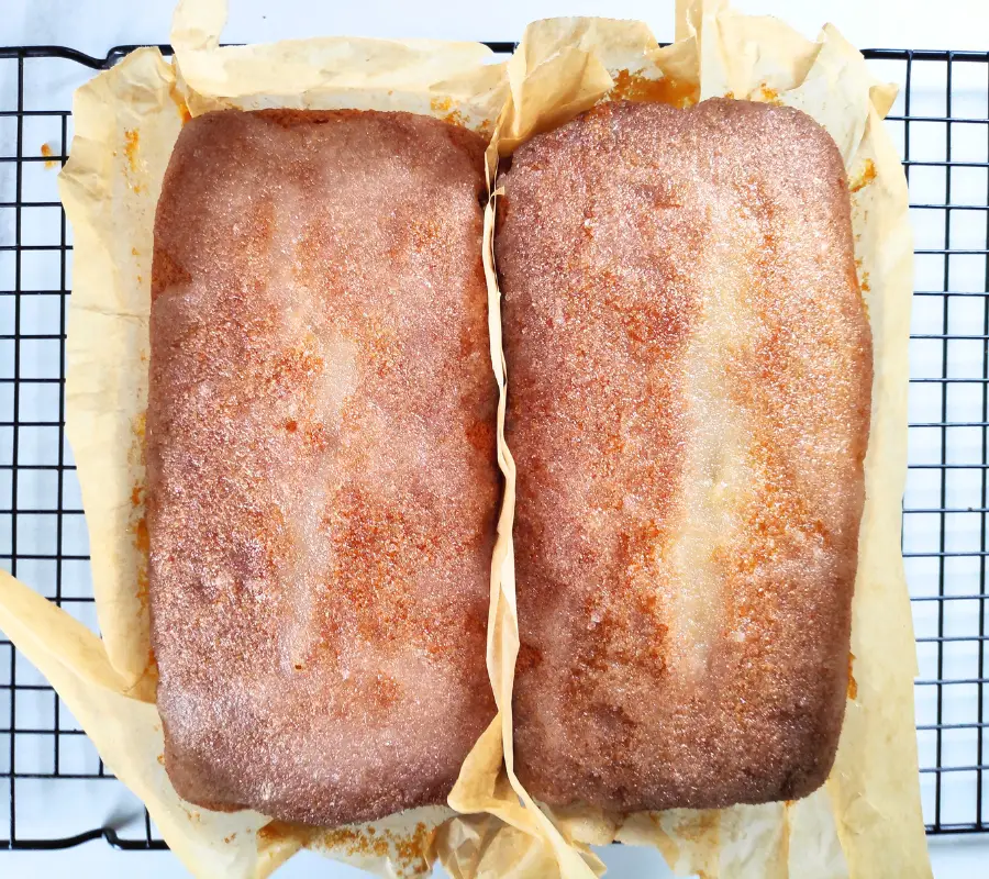 two lemon drizzle cakes wrapped in baking paper