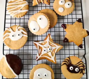 pumpkin spice cookies on a wire rack with Halloween faces uk recipe