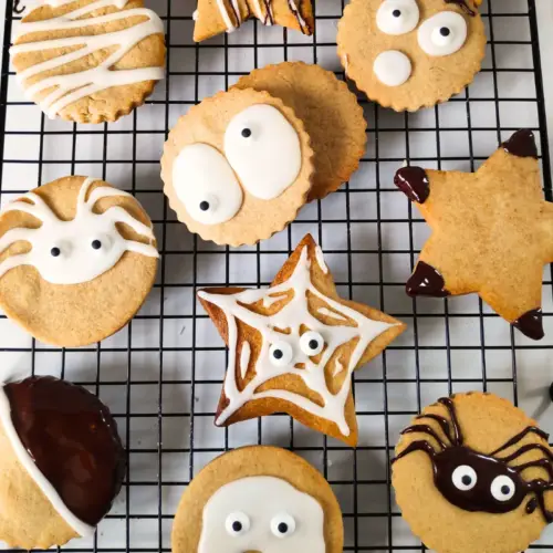 pumpkin spice cookies on a wire rack with Halloween faces uk recipe