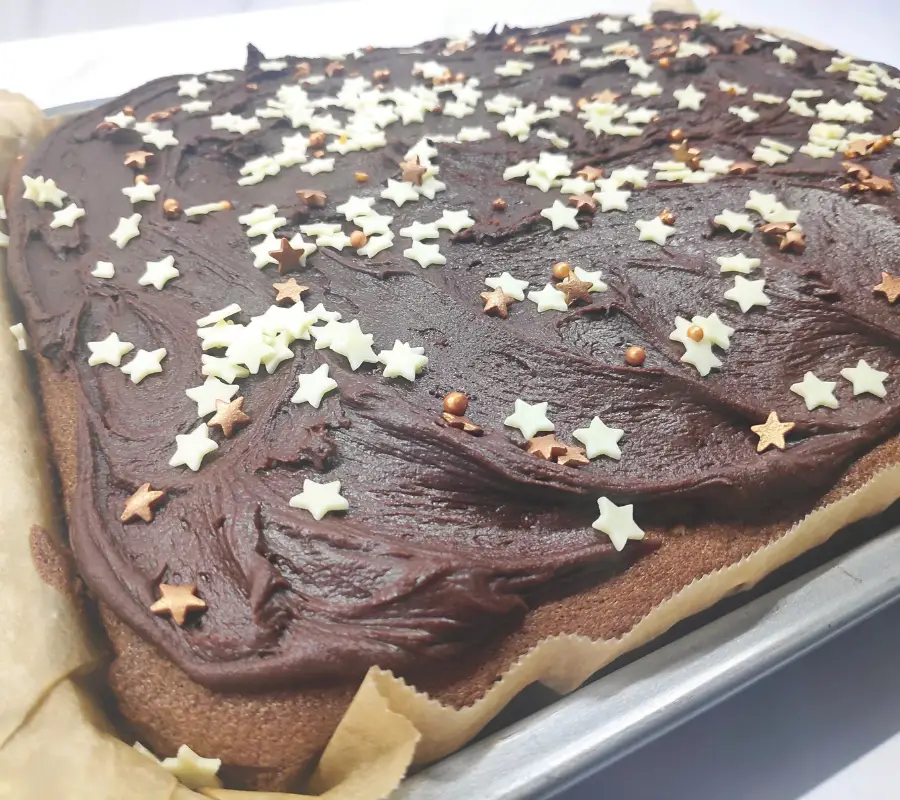 chocolate traybake topped with chocolate icing and star decorations