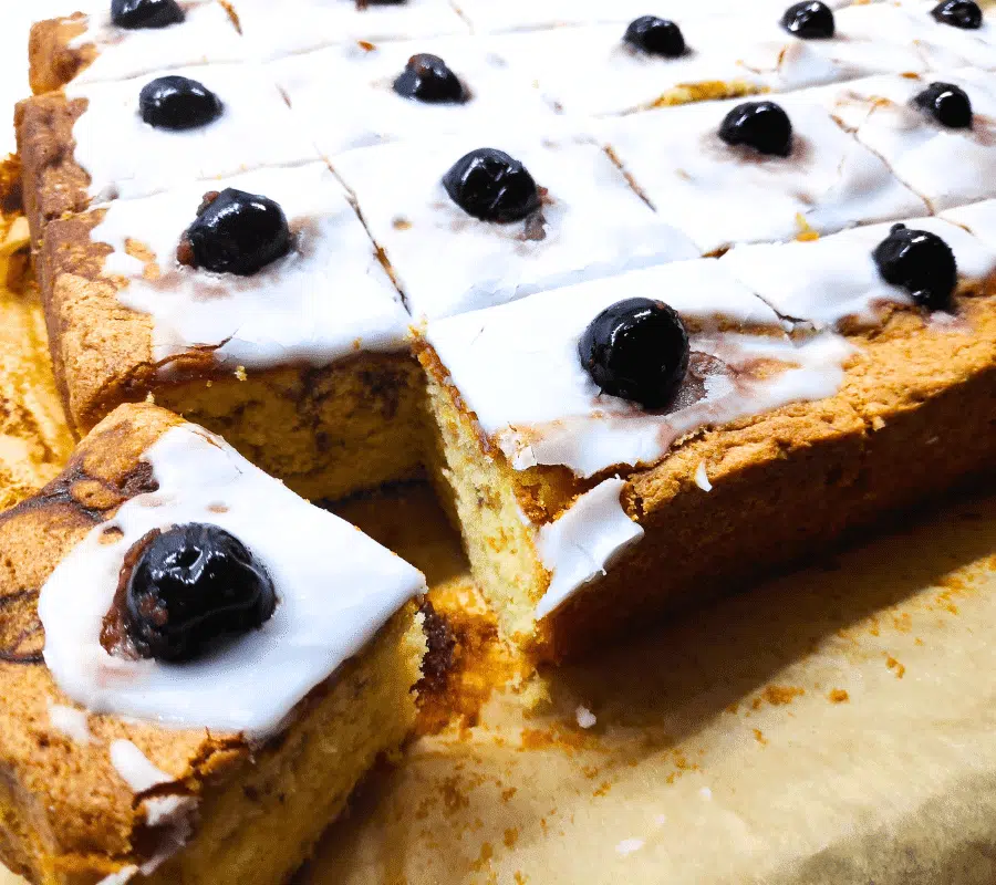 plain marble sponge traybake topped with icing and cherries