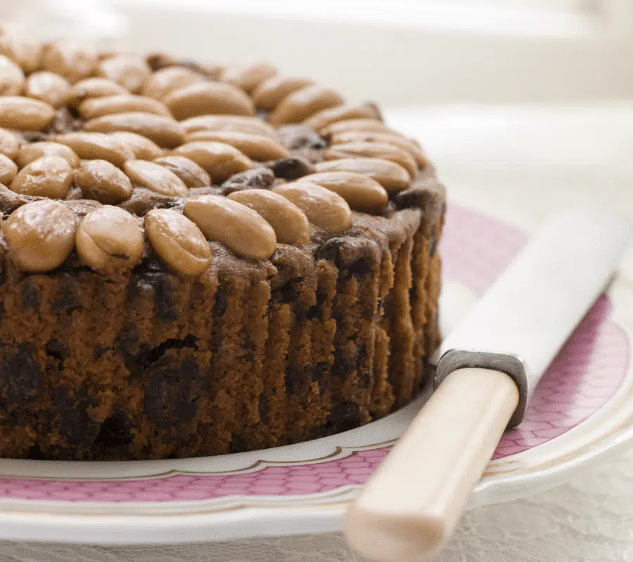 dundee cake on a plate with a knife