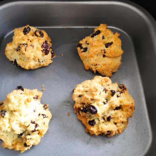 four baked rock cakes on a baking tray in a air fryer