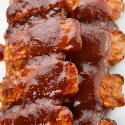 boneless pork ribs covered on bbq sauce for the oven