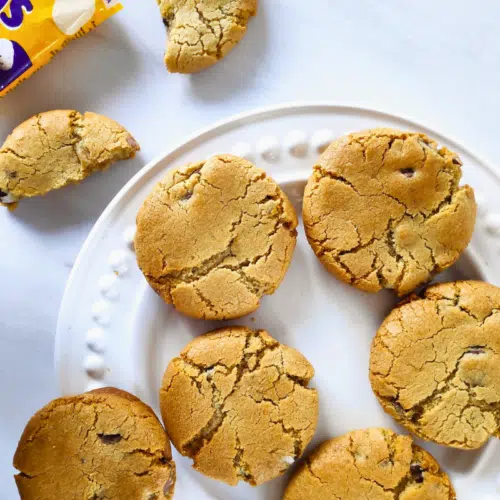 nyc mini egg cookies on a white plate with white background