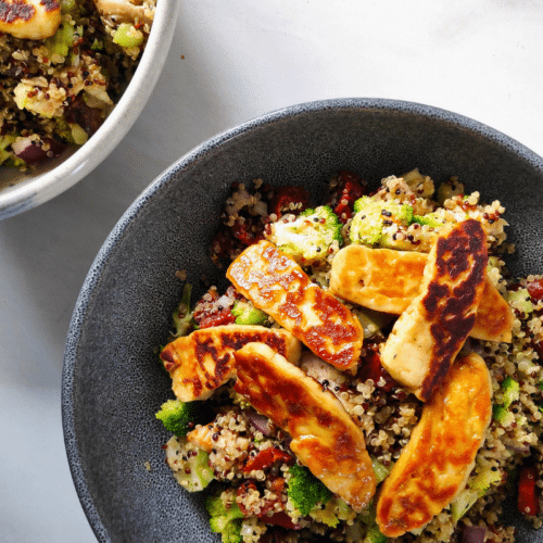pan fried halloumi on quinoa salad in a grey bowl