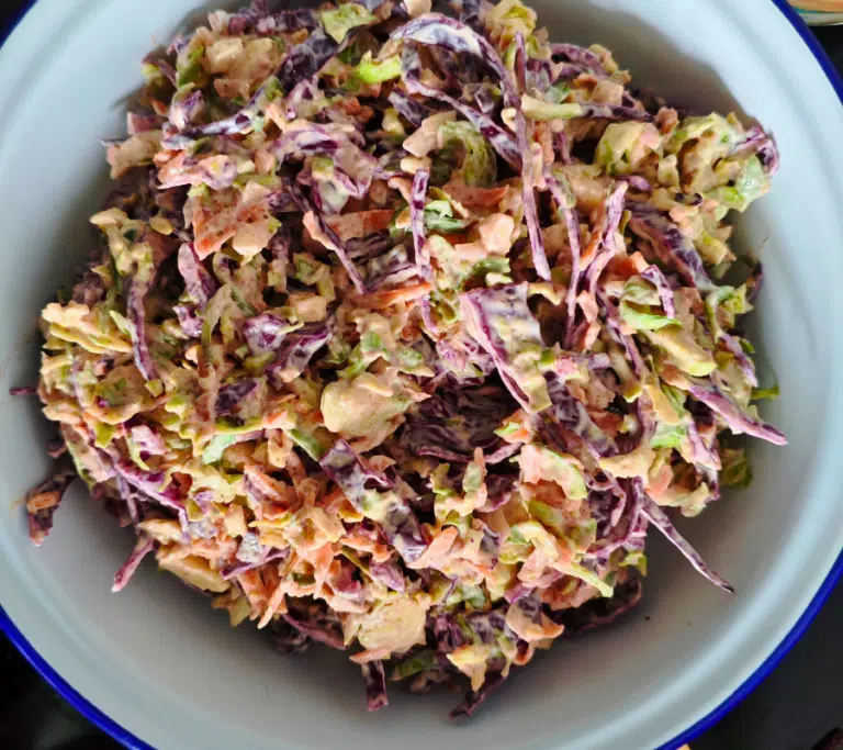 BRUSSELL SPROUT COLESLAW IN A WHITE BOWL