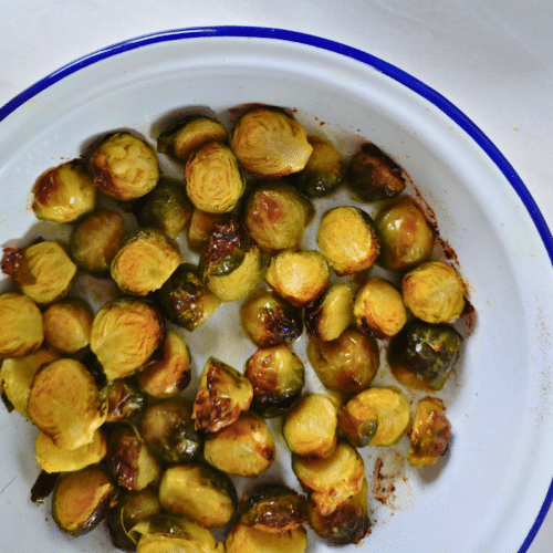 roasted sprouts in a white round dish