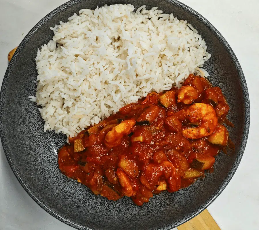 spicy prawns in a ragu tomato sauce served with rice in a bowl