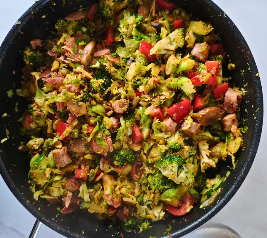 sausage, bacon, sprouts broccoli stirfry in a pan