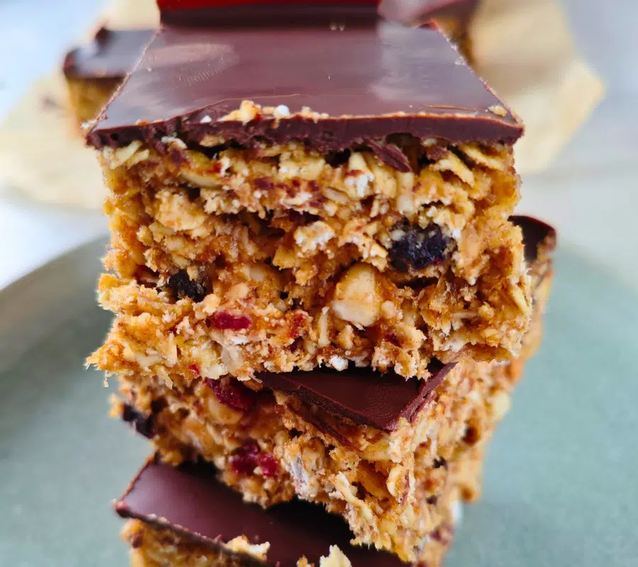 cranberry date flapjacks cut into squares and piled up in a tower of 3