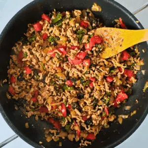 stir fry thai pork mince in a frying pan