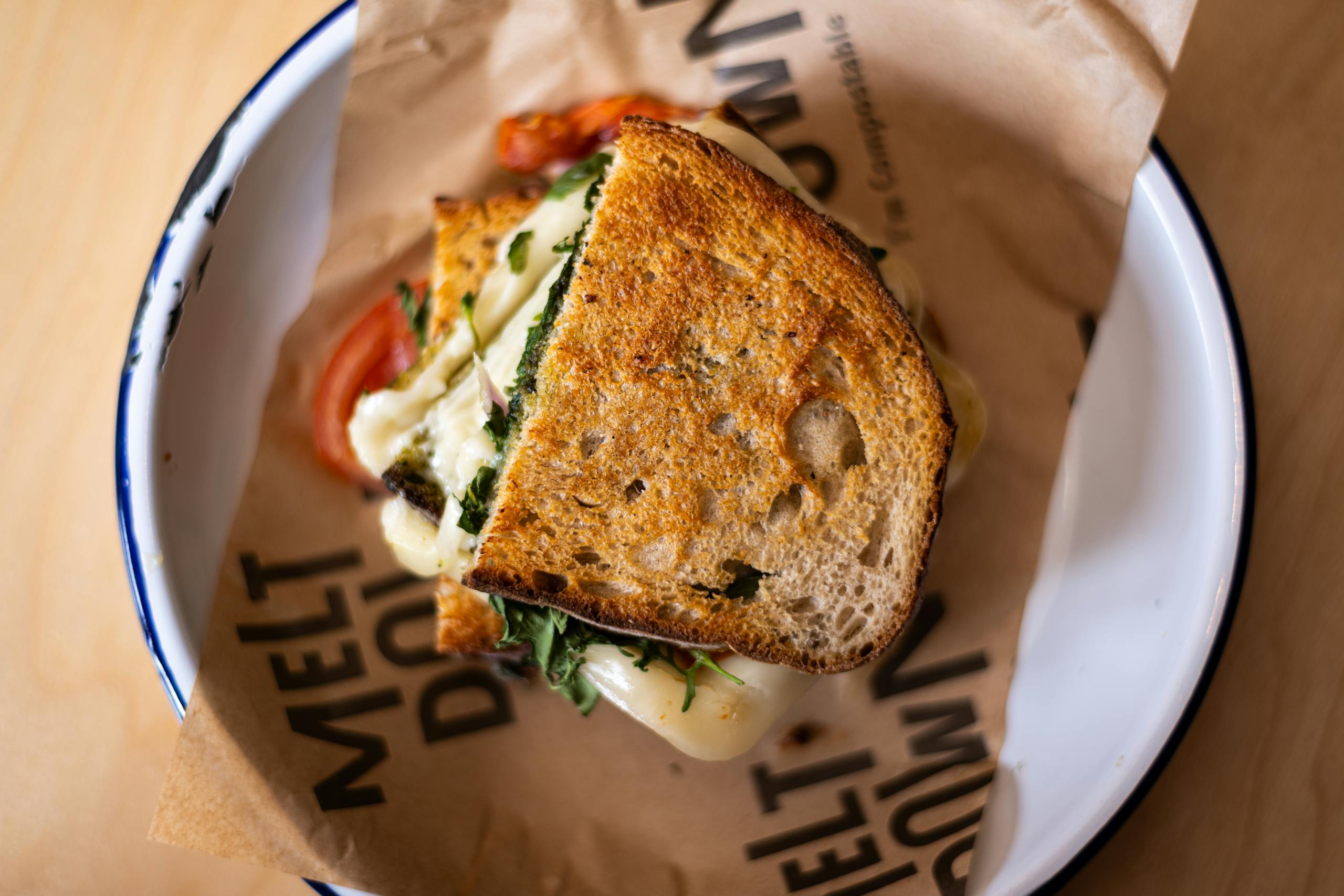 Warm grilled cheese sandwich with herbs and tomatoes served in a Dublin cafe.