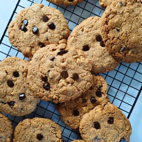 giant chocolate chip and nut cookies on a wire rack
