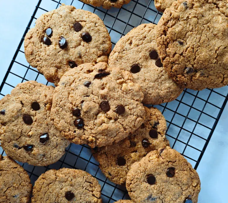 giant chocolate chip and nut cookies on a wire rack