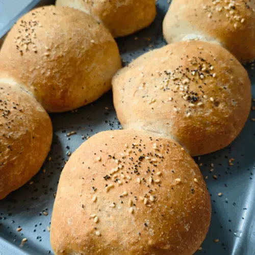 6 burger buns freshly made on a baking tray