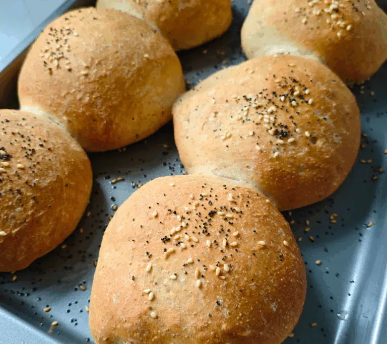 6 burger buns freshly made on a baking tray