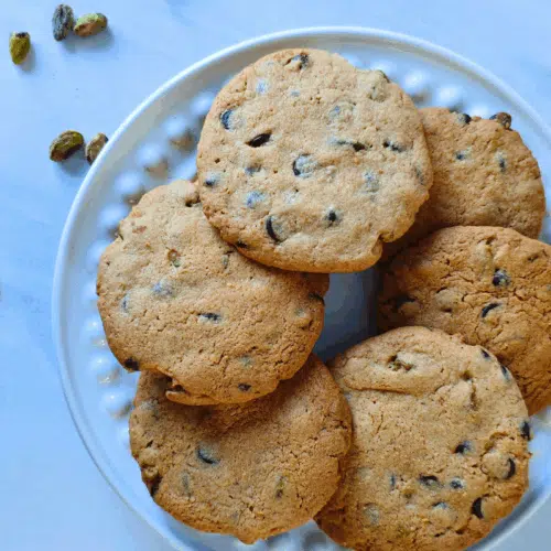 pistashio and chocolate chip cookies on a white plates