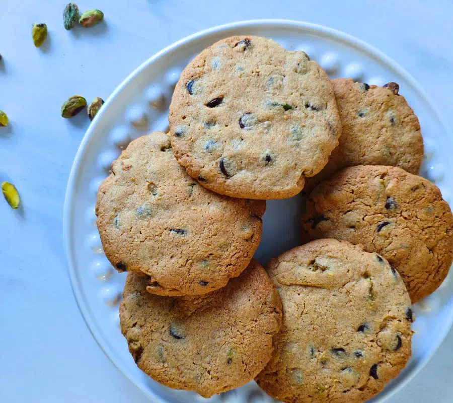 pistashio and chocolate chip cookies on a white plates