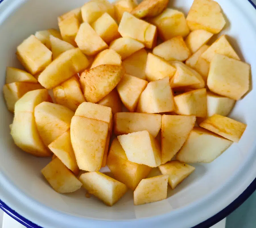 chopped apples in a white oven proof dish