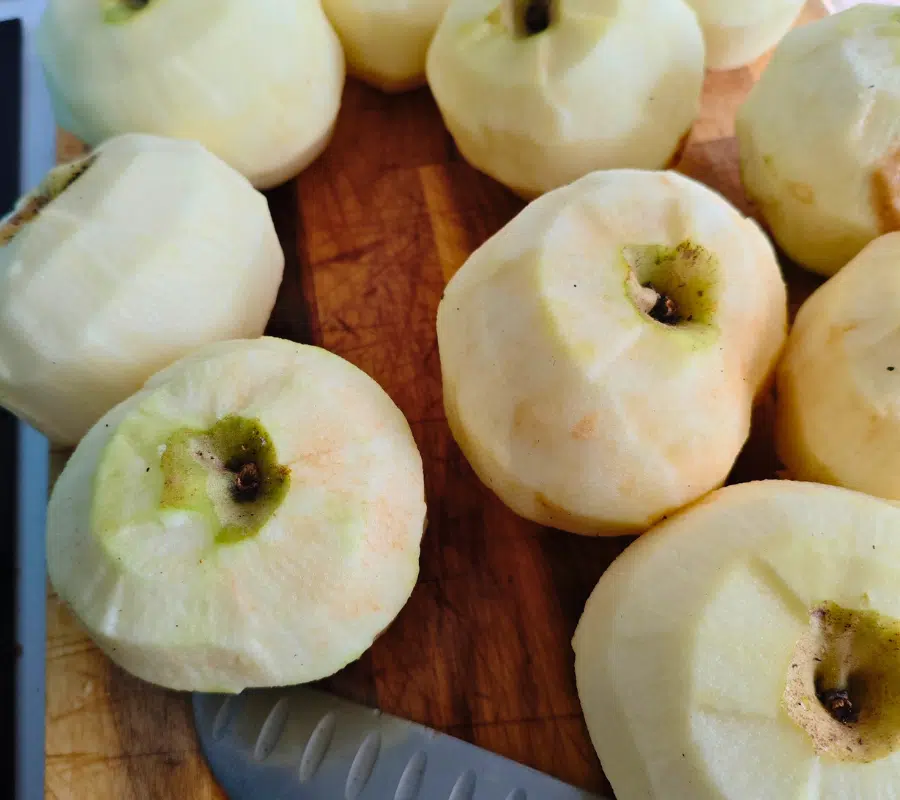 peeling cooking apples on a chopping board