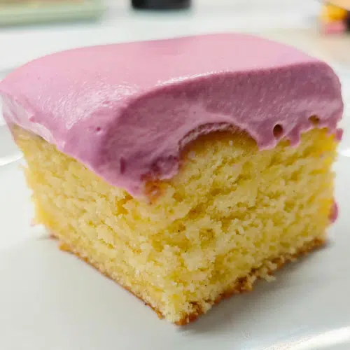 a square slice of plain sponge topped with a blackcurrant yoghurt whip