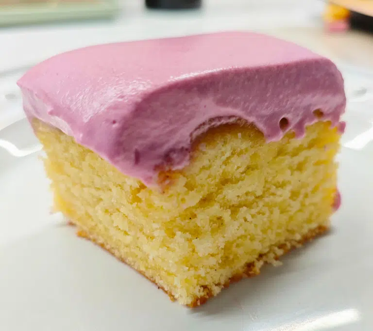 a square slice of plain sponge topped with a blackcurrant yoghurt whip