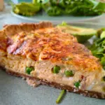 pea and bacon quiche on a plate with salad
